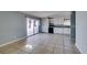 Open living space flows into kitchen, featuring tile floors and natural light at 5239 Elgin Cir, Las Vegas, NV 89122