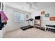 Bright bedroom featuring a treadmill, weights, motivational wall art, and a ceiling fan at 6005 Crystal Talon St, Las Vegas, NV 89130