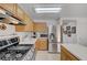 Bright kitchen showcasing stainless steel appliances, tile floors, and light wood cabinets for a modern feel at 6005 Crystal Talon St, Las Vegas, NV 89130