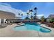 The backyard includes a sparkling pool, spa, palms, a spacious patio, and plenty of privacy at 6005 Crystal Talon St, Las Vegas, NV 89130