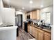 Bright kitchen features wood cabinets, recessed lighting, and stainless steel appliances at 603 Virginia Way, Indian Springs, NV 89018