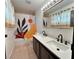 Bathroom with a double sink vanity, large mirror and shower/tub with colorful curtain at 6216 Bullion Blvd, Las Vegas, NV 89103