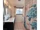 This bathroom has a double vanity with a decorative shower curtain at 6216 Bullion Blvd, Las Vegas, NV 89103