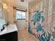 The bathroom features a double vanity, tiled floor, and decorative shower curtain at 6216 Bullion Blvd, Las Vegas, NV 89103