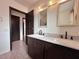 This bathroom has a double vanity and a door to the shower/toilet area at 6216 Bullion Blvd, Las Vegas, NV 89103