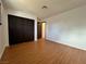 Bedroom features wood-look floors, white walls and a closet with folding dark doors at 6216 Bullion Blvd, Las Vegas, NV 89103