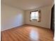 This bedroom features wood floors and a window with decorative curtains at 6216 Bullion Blvd, Las Vegas, NV 89103