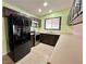 Galley kitchen with stainless appliances, a double door refrigerator, and light countertop at 6216 Bullion Blvd, Las Vegas, NV 89103