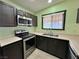 Galley kitchen with stainless appliances, a double sink, and neutral countertop at 6216 Bullion Blvd, Las Vegas, NV 89103