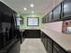 Galley style kitchen with a large stainless steel refrigerator and modern finishes at 6216 Bullion Blvd, Las Vegas, NV 89103