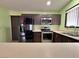Neutral colored kitchen with stainless appliances and double door refrigerator at 6216 Bullion Blvd, Las Vegas, NV 89103