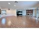 Spacious living room featuring wood-look floors, a brick fireplace and natural light at 6216 Bullion Blvd, Las Vegas, NV 89103