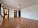 Open living room with hard wood floors and views to walk-in closet and bath at 6216 Bullion Blvd, Las Vegas, NV 89103