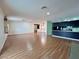 Bright living space next to modern dark-wood kitchen area, featuring wood-look floors at 6216 Bullion Blvd, Las Vegas, NV 89103