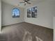 Bright bedroom featuring neutral walls and carpet and large windows with views of the outdoors at 6330 W Azure Dr, Las Vegas, NV 89130