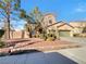 Charming two-story home with a well-manicured front yard and attached two car garage at 6330 W Azure Dr, Las Vegas, NV 89130