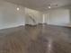 Spacious living room featuring dark floors, a stairway to the upper level, and recessed lighting at 6330 W Azure Dr, Las Vegas, NV 89130