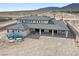 Back view of desert home highlighting an open patio area, mountain backdrop, and lots of space at 6383 Horse Dr, Las Vegas, NV 89131