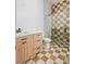 Bathroom featuring patterned tile floors and shower walls and wood vanity at 6383 Horse Dr, Las Vegas, NV 89131