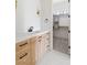 Modern bathroom with a wood vanity, white marble countertop and walk-in closet at 6383 Horse Dr, Las Vegas, NV 89131