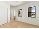 Bright bedroom featuring wood floors, two windows, and white walls for a clean, modern aesthetic at 6383 Horse Dr, Las Vegas, NV 89131