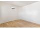 Bright bedroom showcasing the light hardwood floors and neutral decor at 6383 Horse Dr, Las Vegas, NV 89131