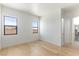 Bright bedroom featuring wood floors, two windows, and white walls for a clean, modern aesthetic at 6383 Horse Dr, Las Vegas, NV 89131