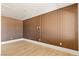 Empty bonus room boasts a statement wall, hardwood floors and recessed lighting at 6383 Horse Dr, Las Vegas, NV 89131