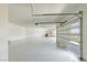 Large garage area with an epoxy floor and modern door at 6383 Horse Dr, Las Vegas, NV 89131