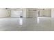 Spacious two-car garage featuring epoxy flooring and modern doors at 6383 Horse Dr, Las Vegas, NV 89131
