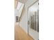 Hallway leads to a modern wine room with custom shelving and a staircase to the home's second level at 6383 Horse Dr, Las Vegas, NV 89131