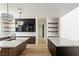 Contemporary kitchen with stainless steel sink, marble countertops, and custom black and wood-toned cabinets at 6383 Horse Dr, Las Vegas, NV 89131