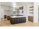 Beautiful kitchen showcasing dual islands with countertop that has marble-look veining, stylish pendant lights and warm wood accents at 6383 Horse Dr, Las Vegas, NV 89131