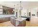 Bright kitchen with stainless steel sink, marble countertops, and custom cabinets in neutral wood tones at 6383 Horse Dr, Las Vegas, NV 89131