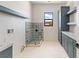 Bright laundry area with patterned shower and abundant cabinet space at 6383 Horse Dr, Las Vegas, NV 89131
