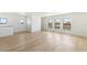 Bright living room with wood flooring and large windows showcasing mountain views at 6383 Horse Dr, Las Vegas, NV 89131