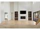 Bright living room showcasing a fireplace with decorative molding and built-in cabinets and shelving at 6383 Horse Dr, Las Vegas, NV 89131