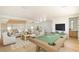 Living room with a pool table, wet bar, comfortable seating, and modern decor at 6383 Horse Dr, Las Vegas, NV 89131