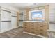 Spacious walk-in closet with custom cabinets, drawers and a large window at 6383 Horse Dr, Las Vegas, NV 89131