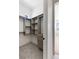 Well-organized walk-in closet featuring custom shelving, drawer storage, plush carpeting, and an abundance of natural light at 6383 Horse Dr, Las Vegas, NV 89131