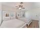 Bright bedroom featuring two beds, modern ceiling fan, and illuminated headboards, offering a stylish and comfortable space at 6408 Starcrest Dr, Las Vegas, NV 89108