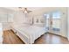 Bright bedroom featuring two beds, ceiling fan, and backyard access at 6408 Starcrest Dr, Las Vegas, NV 89108