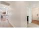 Hallway view showing access to various rooms including the kitchen, bathroom, and front entrance with consistent flooring at 6408 Starcrest Dr, Las Vegas, NV 89108