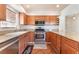 This kitchen features stainless steel appliances, granite countertops, and wood cabinets at 6408 Starcrest Dr, Las Vegas, NV 89108