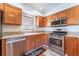 Well-appointed kitchen features stainless steel appliances, granite countertops, and wood cabinets at 6408 Starcrest Dr, Las Vegas, NV 89108