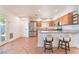 Bright kitchen features stainless steel appliances, granite countertops, and breakfast bar seating at 6408 Starcrest Dr, Las Vegas, NV 89108