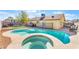 Beautiful in-ground pool with a connected hot tub and fenced-in yard at 6408 Starcrest Dr, Las Vegas, NV 89108