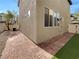 Low maintenance backyard featuring pavers, artificial grass, and desert landscaping at 6786 Wormwood Ln, Las Vegas, NV 89148