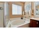 Bathroom showcasing a soaking tub with tile surround and a separate glass-enclosed shower at 6816 Royal Poinciana Ct, Las Vegas, NV 89131