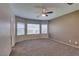 Serene bedroom with plush carpeting, a ceiling fan, and large windows offering plenty of natural light at 6816 Royal Poinciana Ct, Las Vegas, NV 89131